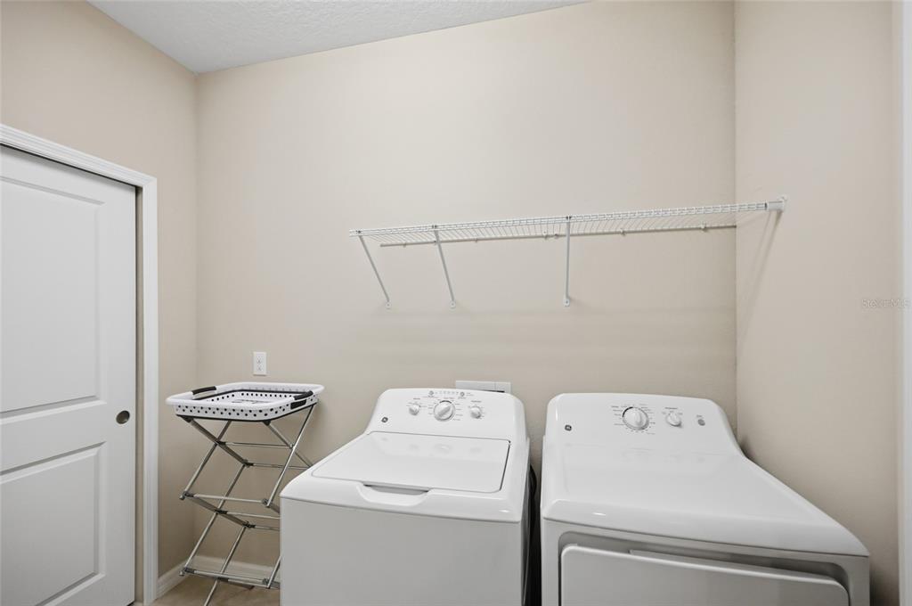 13837 Messina Loop, Unit 101 Bradenton, FL 34211 - Photo 23 of 51 a view of storage and utility room with washer and dryer