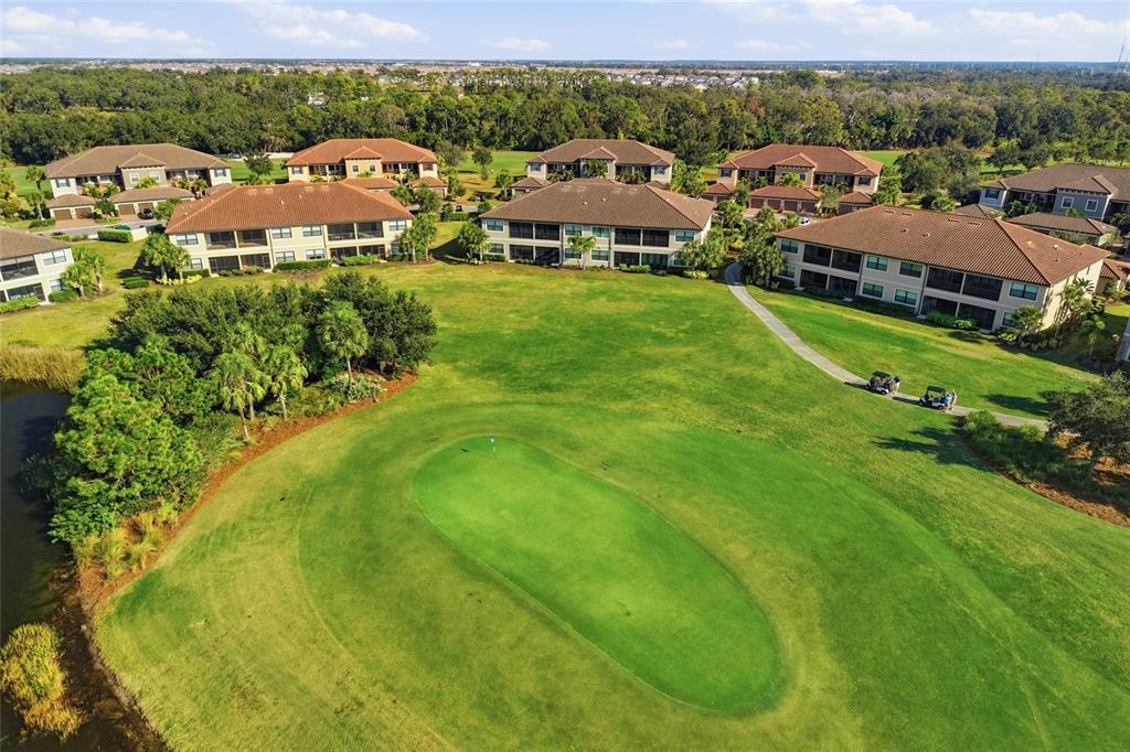 13837 Messina Loop, Unit 101 Bradenton, FL 34211 - Photo 27 of 51 an aerial view of residential houses with outdoor space and trees