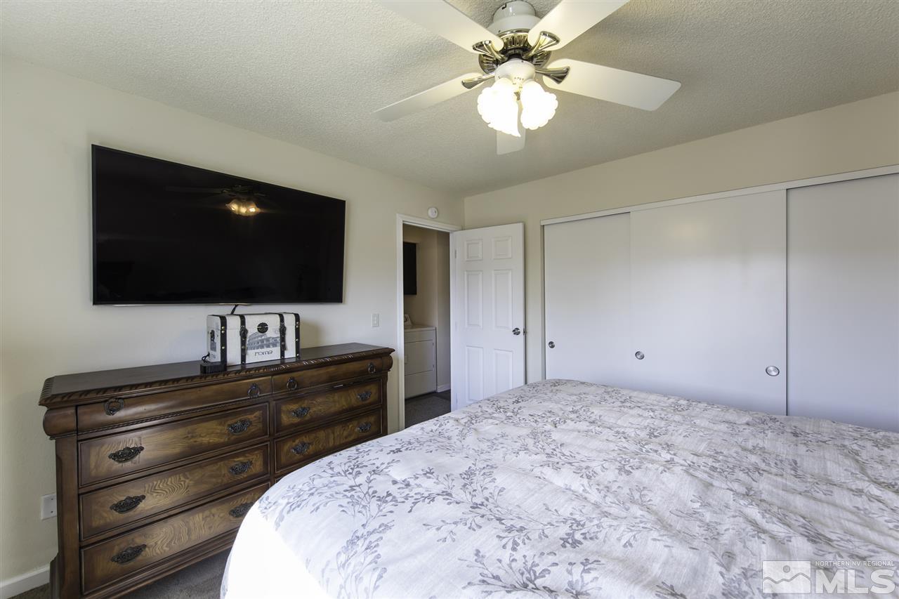 13860 Lear Boulevard Reno, NV 89506 - Photo 12 of 22 a bedroom with a bed and a flat screen tv