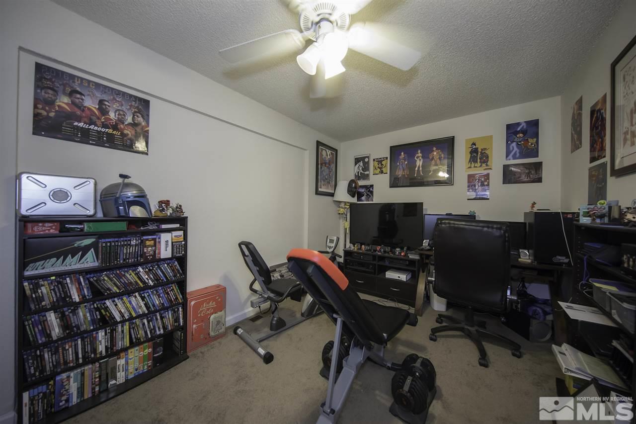 13860 Lear Boulevard Reno, NV 89506 - Photo 13 of 22 a view of a workspace with furniture and a ceiling fan