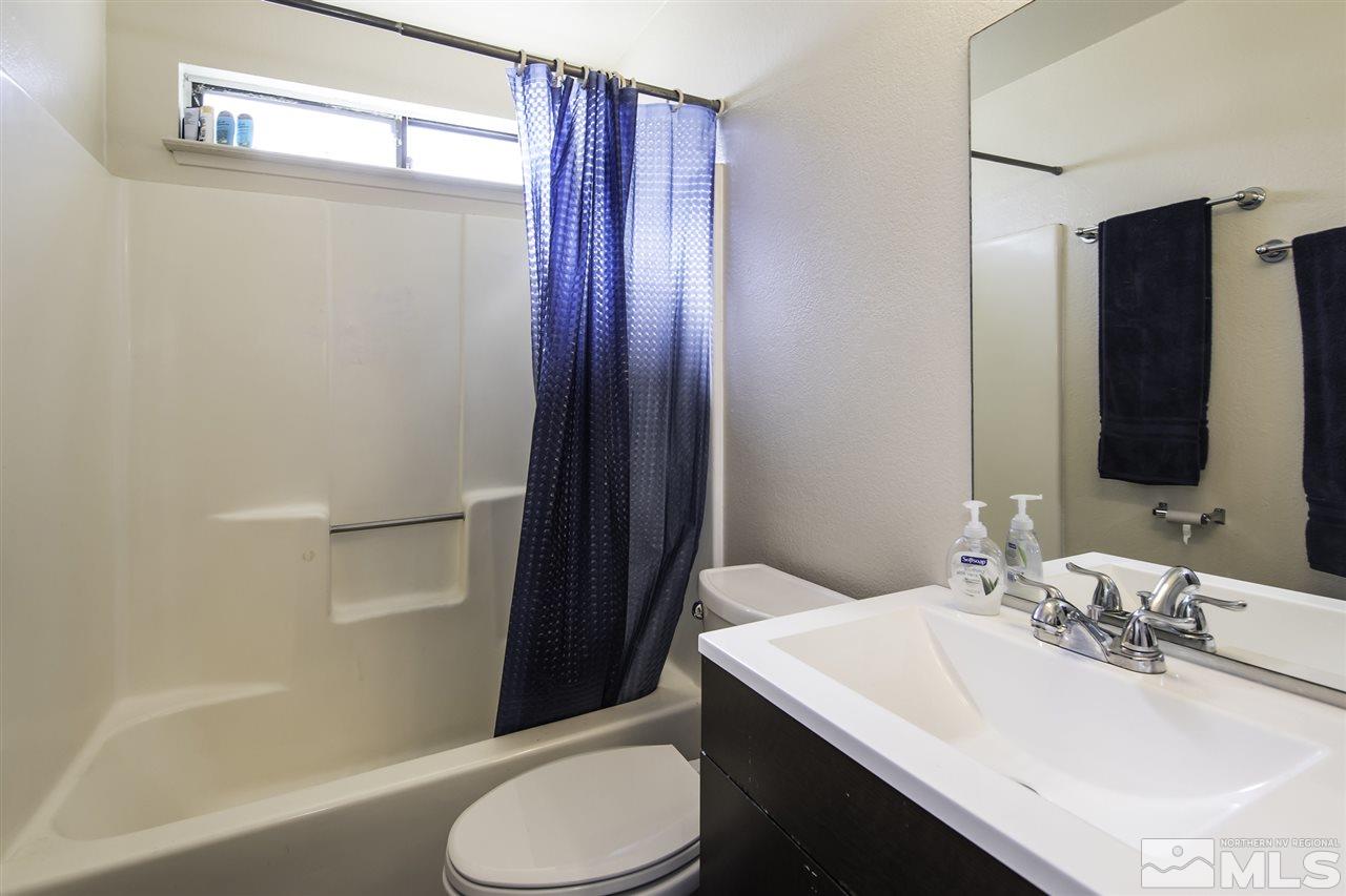 13860 Lear Boulevard Reno, NV 89506 - Photo 14 of 22 a bathroom with a sink toilet and shower