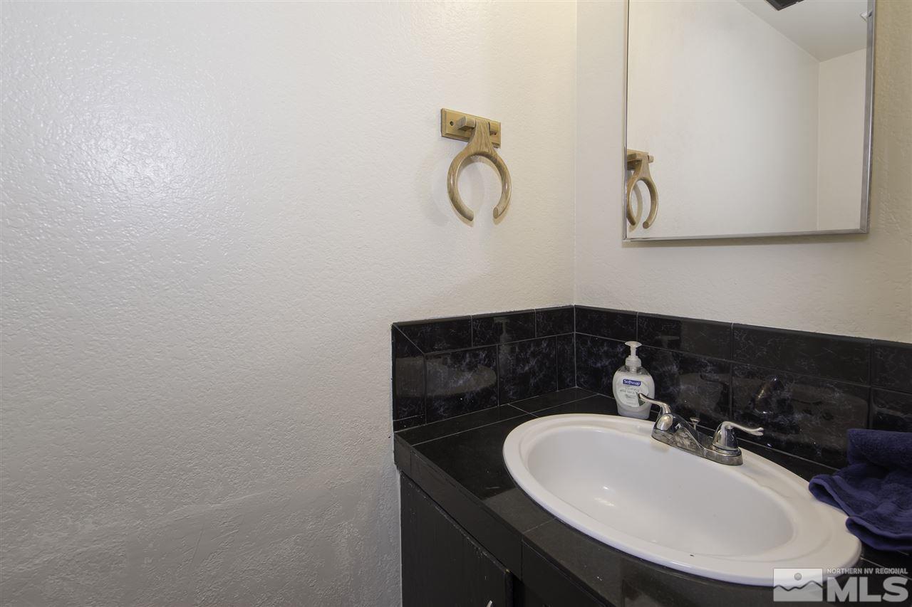 13860 Lear Boulevard Reno, NV 89506 - Photo 5 of 22 a bathroom with a sink and a mirror