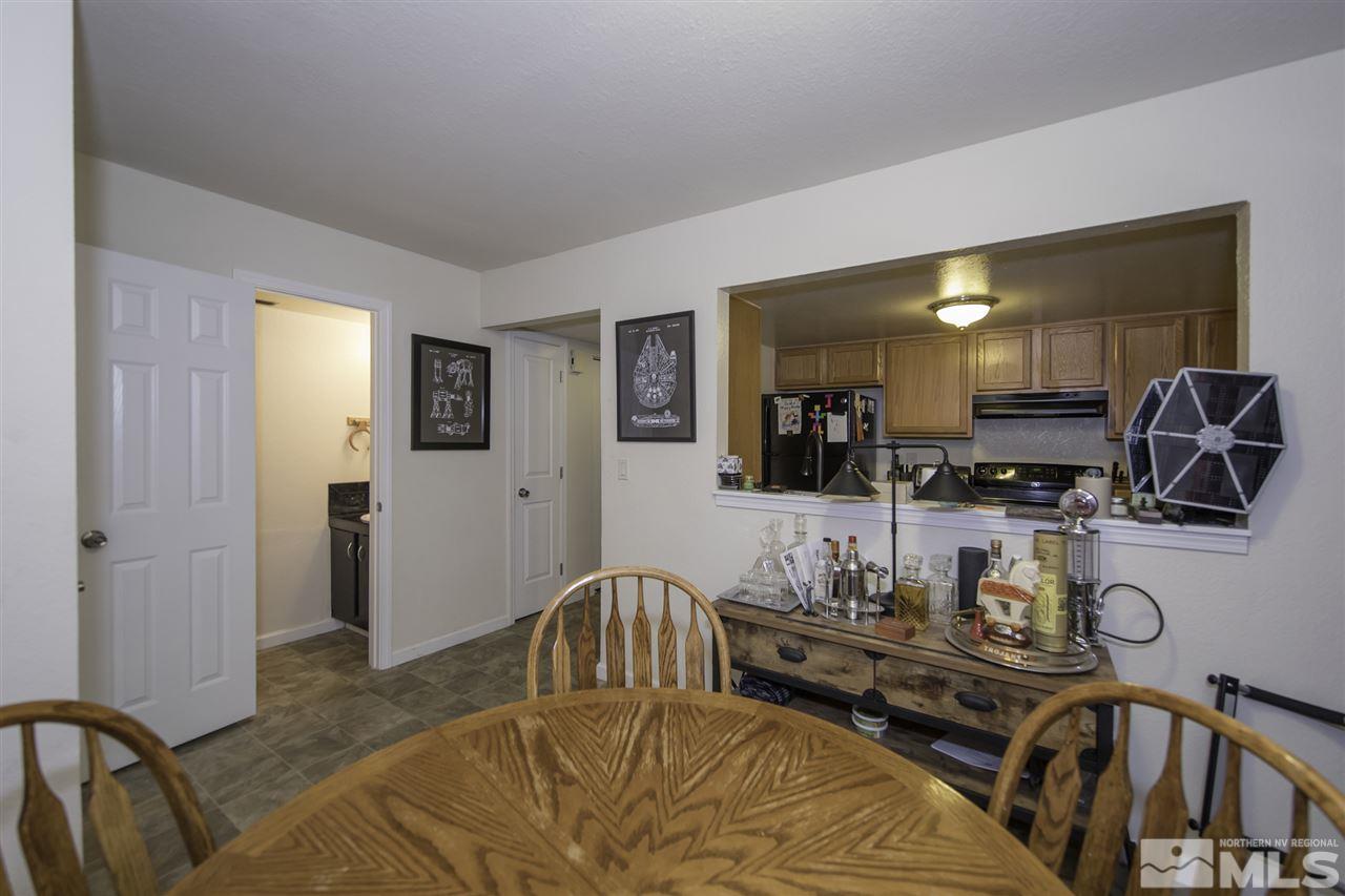 13860 Lear Boulevard Reno, NV 89506 - Photo 7 of 22 a dining room with furniture and mirror