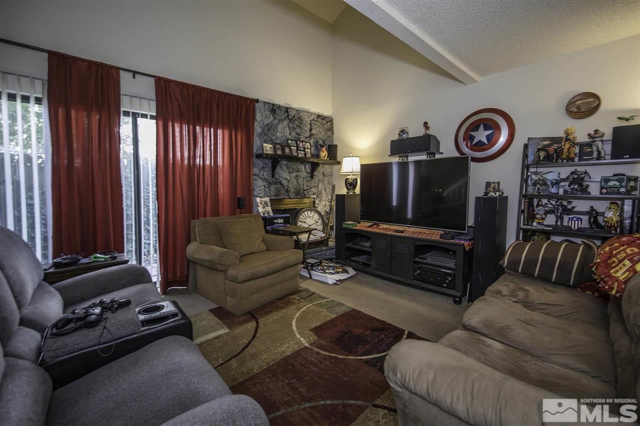 13860 Lear Boulevard Reno, NV 89506 - Photo 9 of 22 a living room with furniture a couch and a flat screen tv