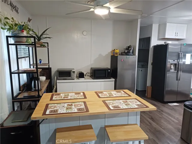 a kitchen with a refrigerator and a stove