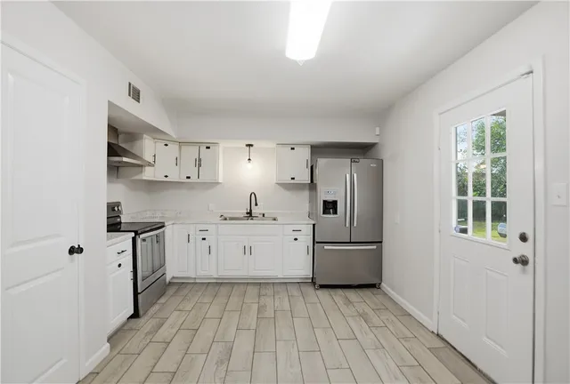 a kitchen with cabinets and stainless steel appliances