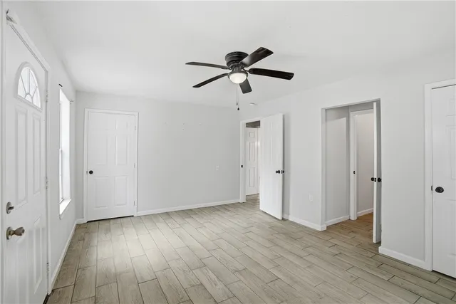 a view of empty room with wooden floor