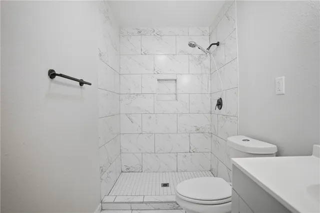 a bathroom with a toilet and a shower