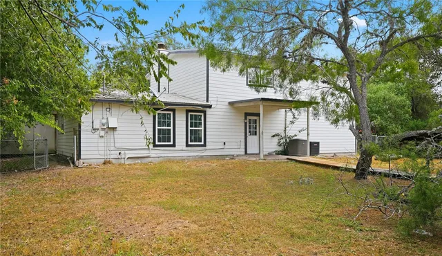 a house that has a tree in front of it
