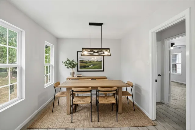 a dining room with furniture and window