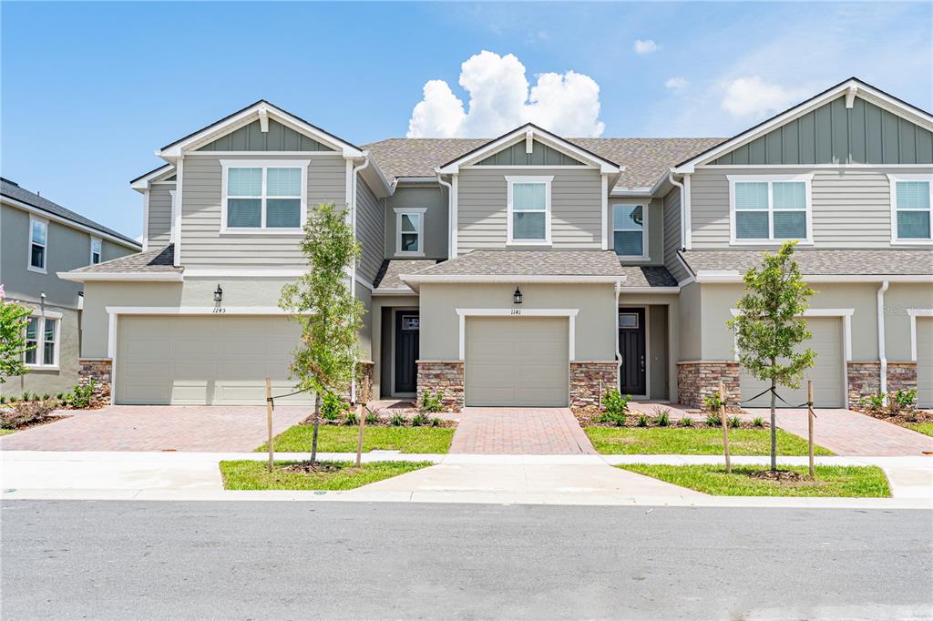 1141 Seaside Mist Trail Kissimmee, FL 34747 - Photo 1 of 30 a front view of a house with a yard and garage