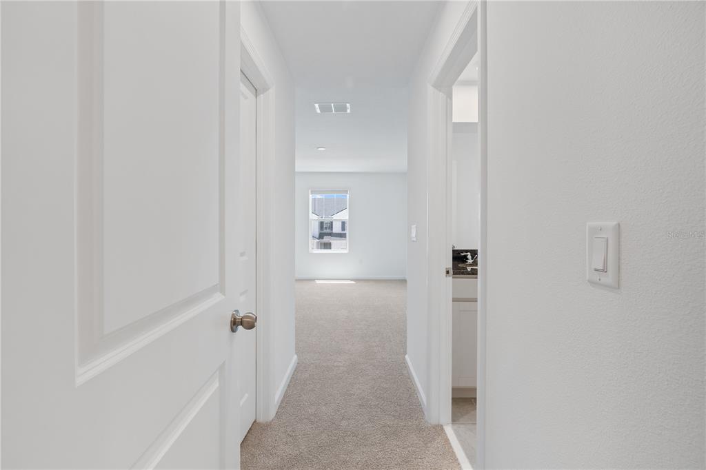 1141 Seaside Mist Trail Kissimmee, FL 34747 - Photo 21 of 30 a view of a hallway with a white walls