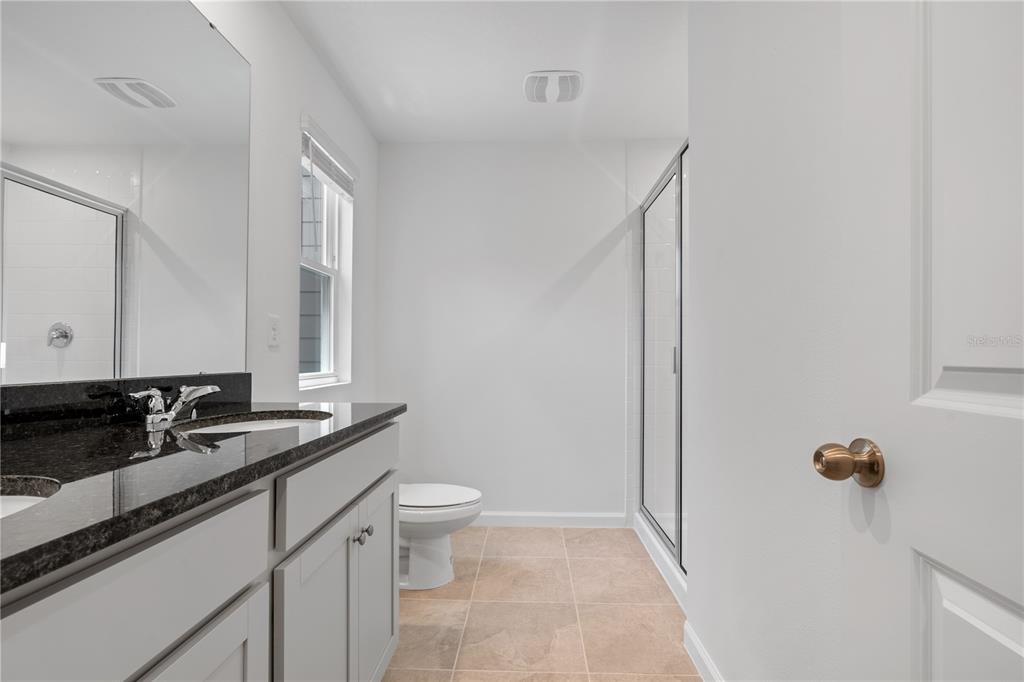 1141 Seaside Mist Trail Kissimmee, FL 34747 - Photo 25 of 30 a bathroom with a sink and a mirror