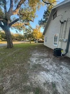 a view of a house with backyard and trees