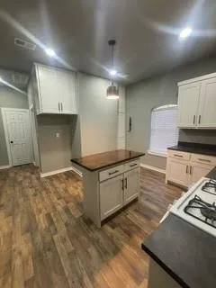a kitchen with a sink stove and cabinets
