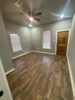 en empty room with windows and cabinet