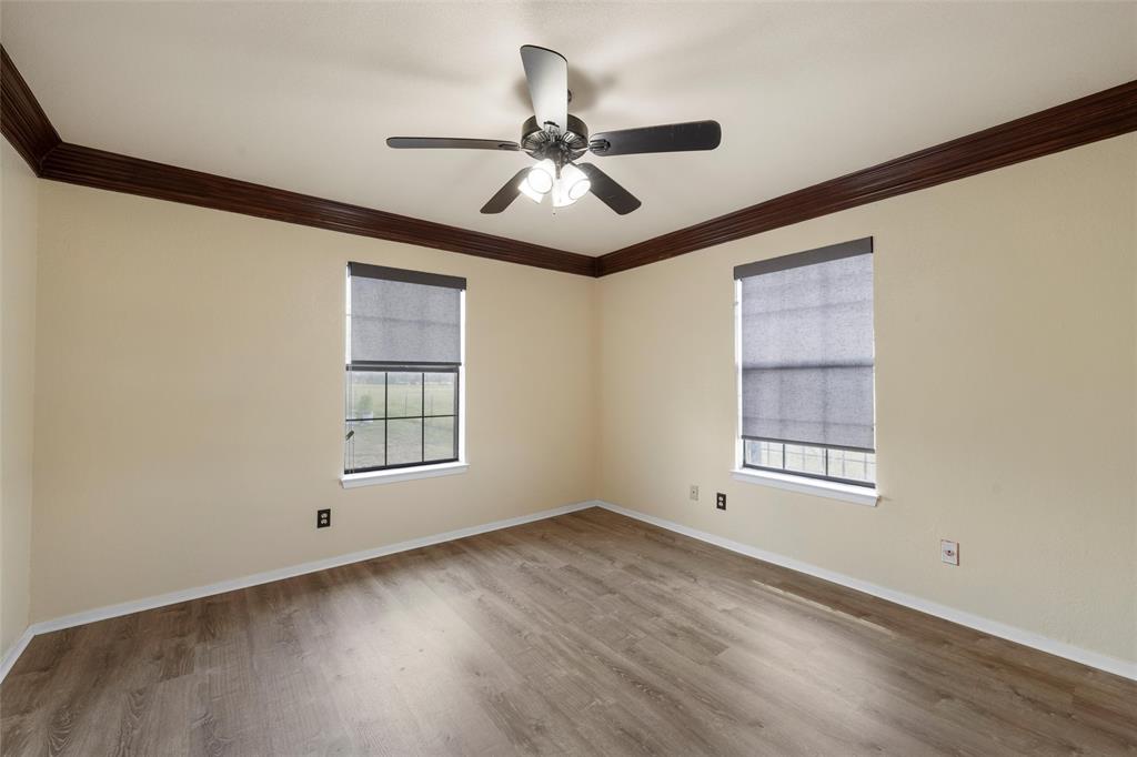 3433 West Tours Road West, TX 76691 - Photo 29 of 40 Spare room with light wood-style flooring, crown molding, and a ceiling fan