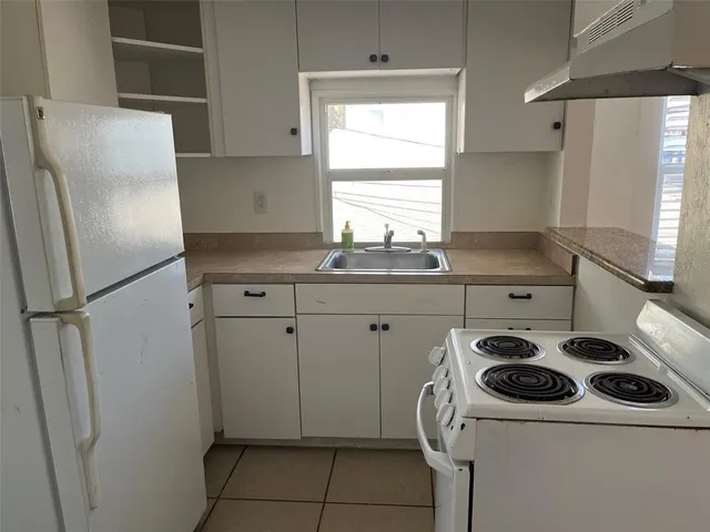 a kitchen with a sink a stove and refrigerator