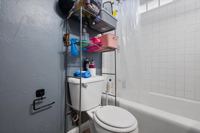 a bathroom with a toilet and a bathtub