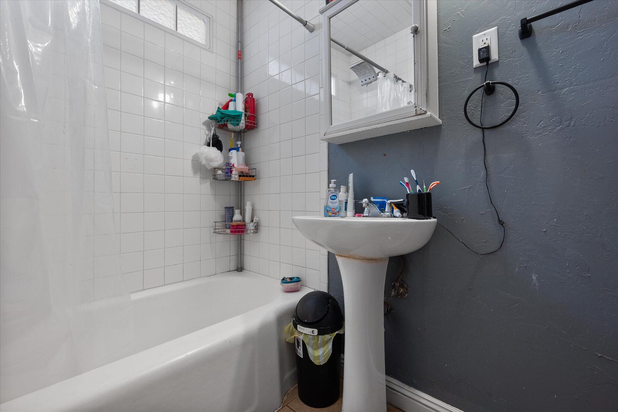 5006 42nd Street Lubbock, TX 79414 - Photo 13 of 19 a bathroom with a sink a toilet and bathtub