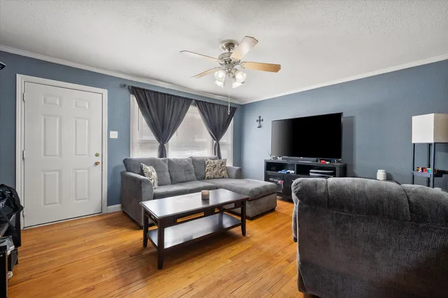 a living room with furniture and a flat screen tv