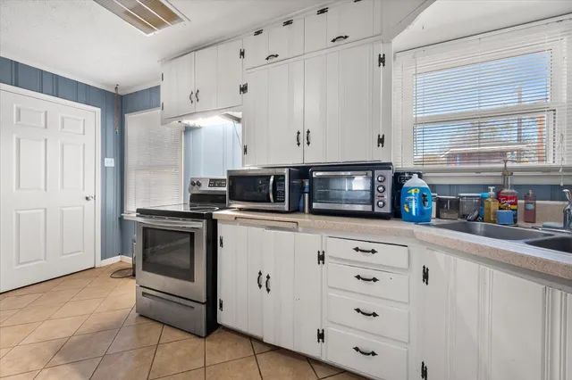 a kitchen with stainless steel appliances granite countertop a sink and a stove