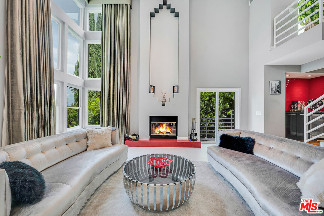 13563 Contour Drive Sherman Oaks, CA 91423 - Photo 1 of 37 a living room with furniture and a fireplace