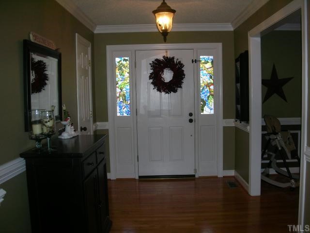 7617 Kennebec Road Willow Spring, NC 27592 - Photo 6 of 12 Entry foyer offers warm greeting from rocking chair front porch. Hall closet, chair rail, crown molding, hardwoods a special way to greet guests.