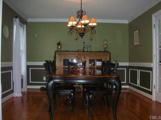 7617 Kennebec Road Willow Spring, NC 27592 - Photo 7 of 12 Dining room large enough for a table with leaf and buffet. Designer chandelier, butler door to kitchen, crown/chair molding, hardwood.