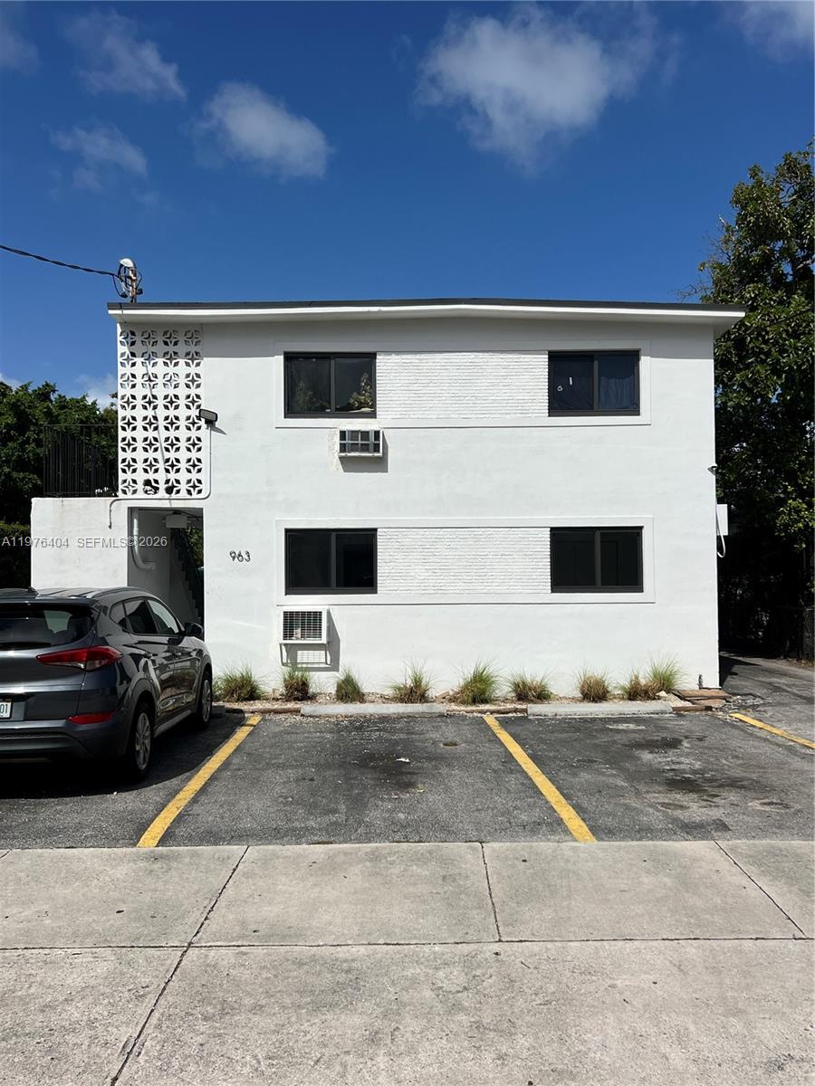 963 Northwest 5th Street, Unit 3 Miami, FL 33128 - Photo 1 of 12 a car parked in front of a building