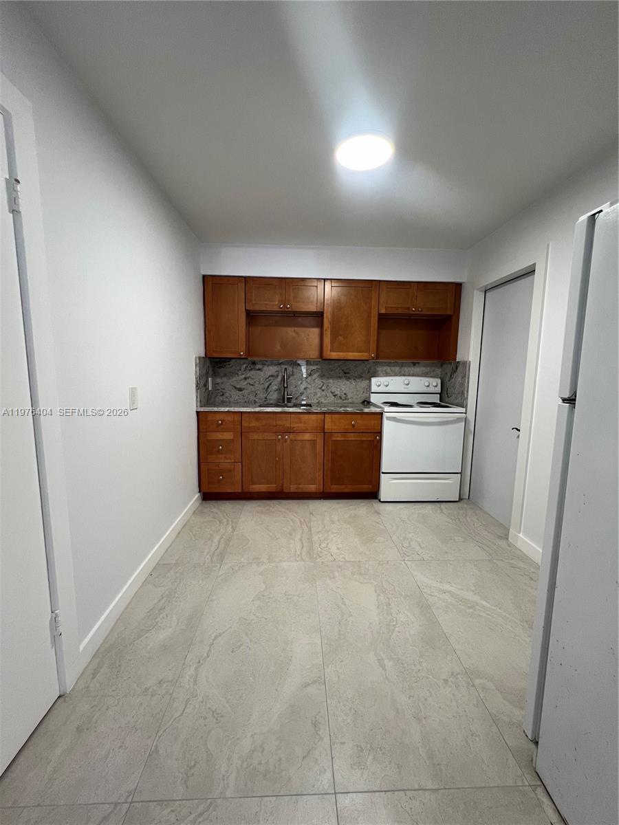 963 Northwest 5th Street, Unit 3 Miami, FL 33128 - Photo 3 of 12 a living room with stainless steel appliances furniture a rug and a window