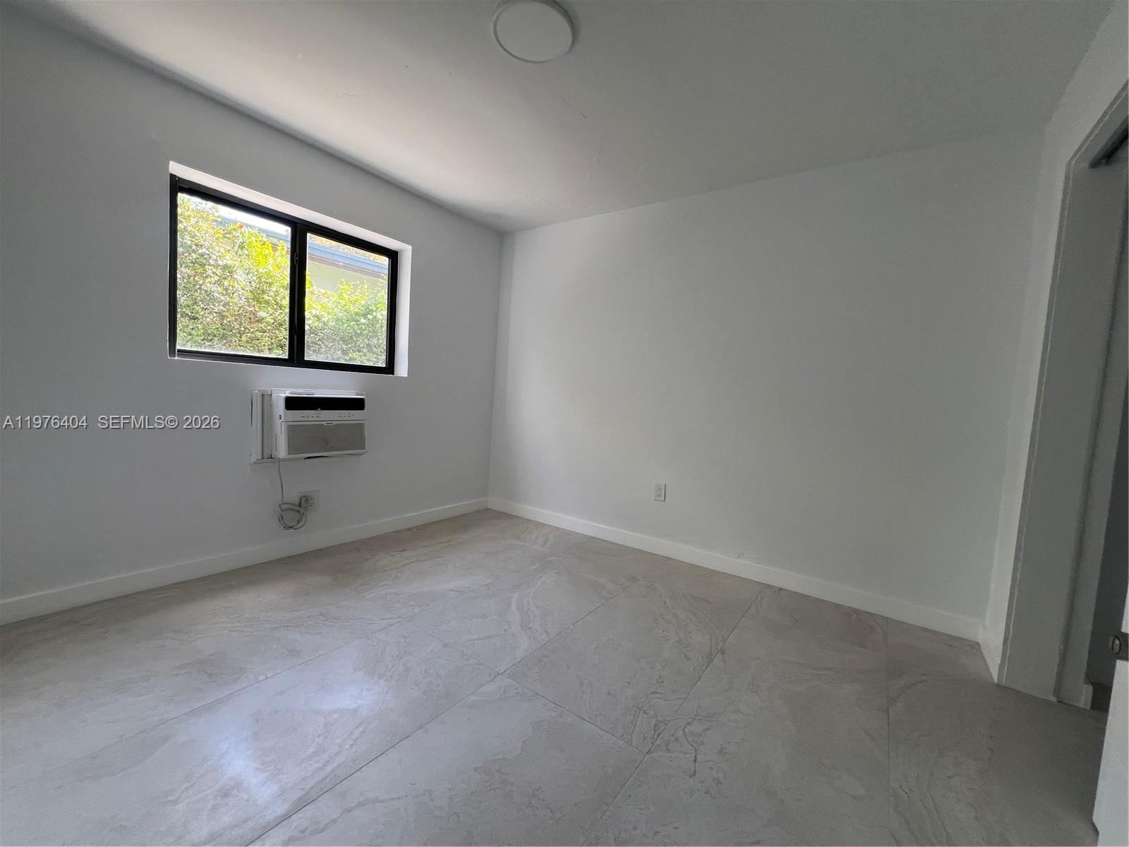 963 Northwest 5th Street, Unit 3 Miami, FL 33128 - Photo 8 of 12 an empty room with windows