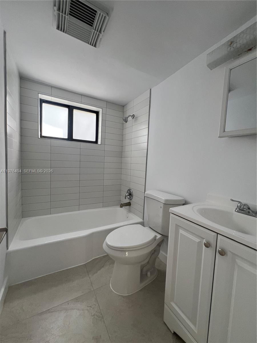 963 Northwest 5th Street, Unit 3 Miami, FL 33128 - Photo 9 of 12 a bathroom with a sink a toilet and a bathtub