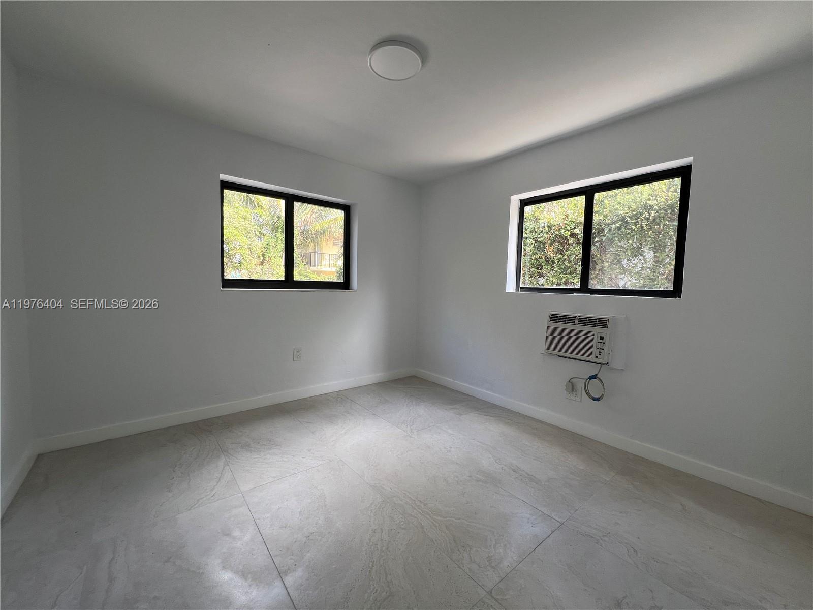963 Northwest 5th Street, Unit 3 Miami, FL 33128 - Photo 10 of 12 an empty room with windows