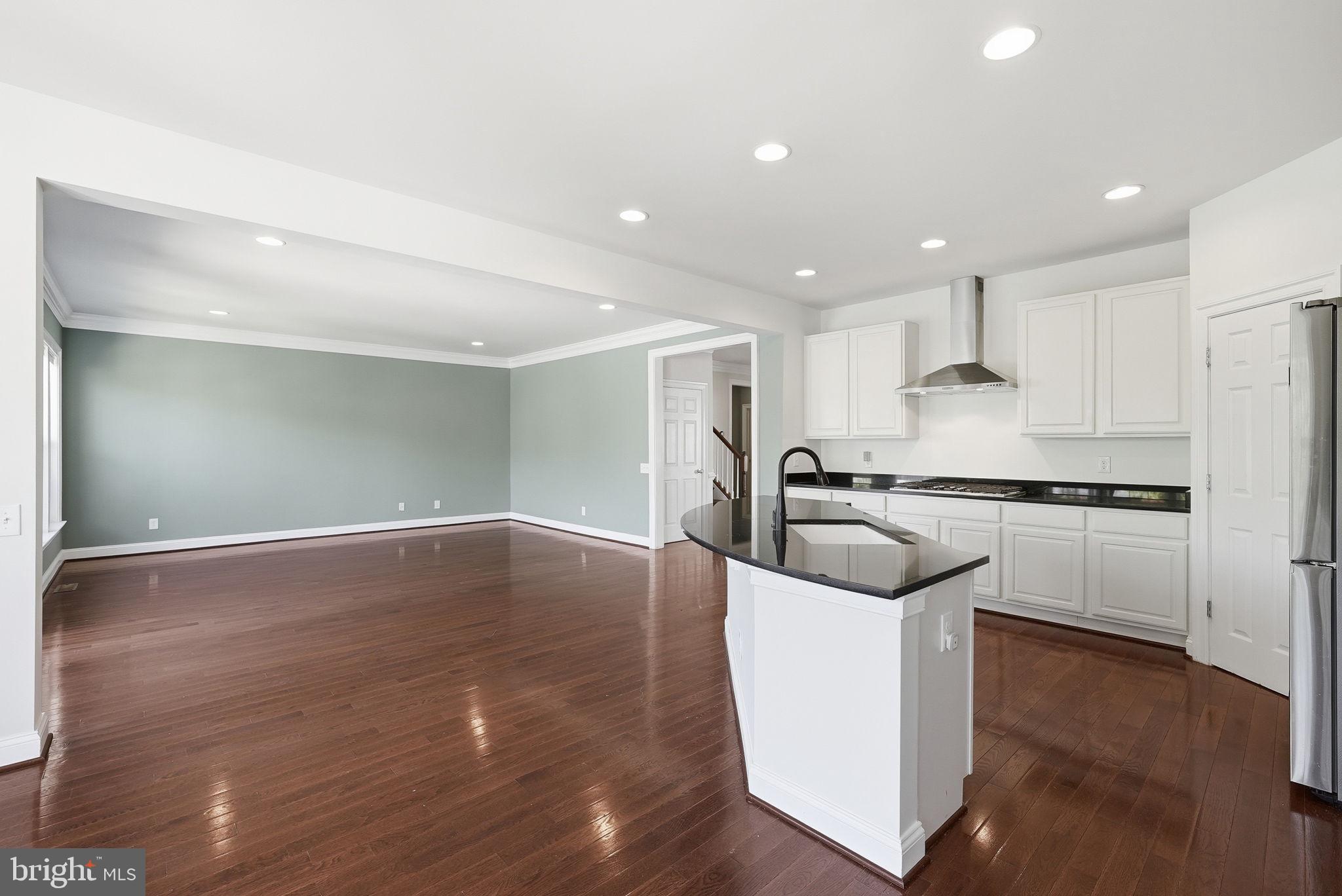42330 Christophers View Terrace Ashburn, VA 20148 - Photo 15 of 46 a large kitchen with stainless steel appliances granite countertop a stove a sink and a refrigerator