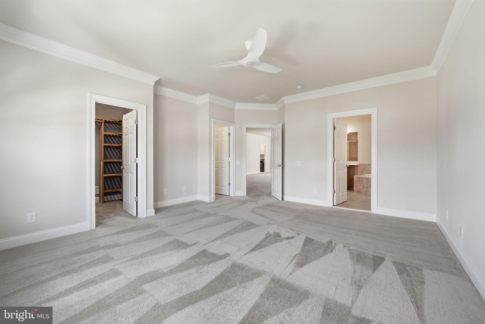 42330 Christophers View Terrace Ashburn, VA 20148 - Photo 28 of 46 a view of an empty room with wooden floor and kitchen view