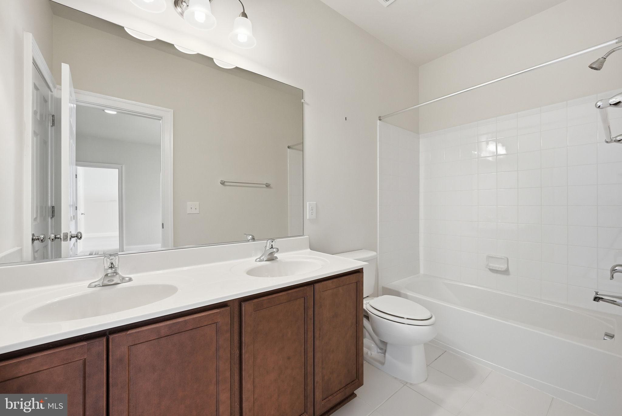 42330 Christophers View Terrace Ashburn, VA 20148 - Photo 32 of 46 a bathroom with a sink a toilet and shower