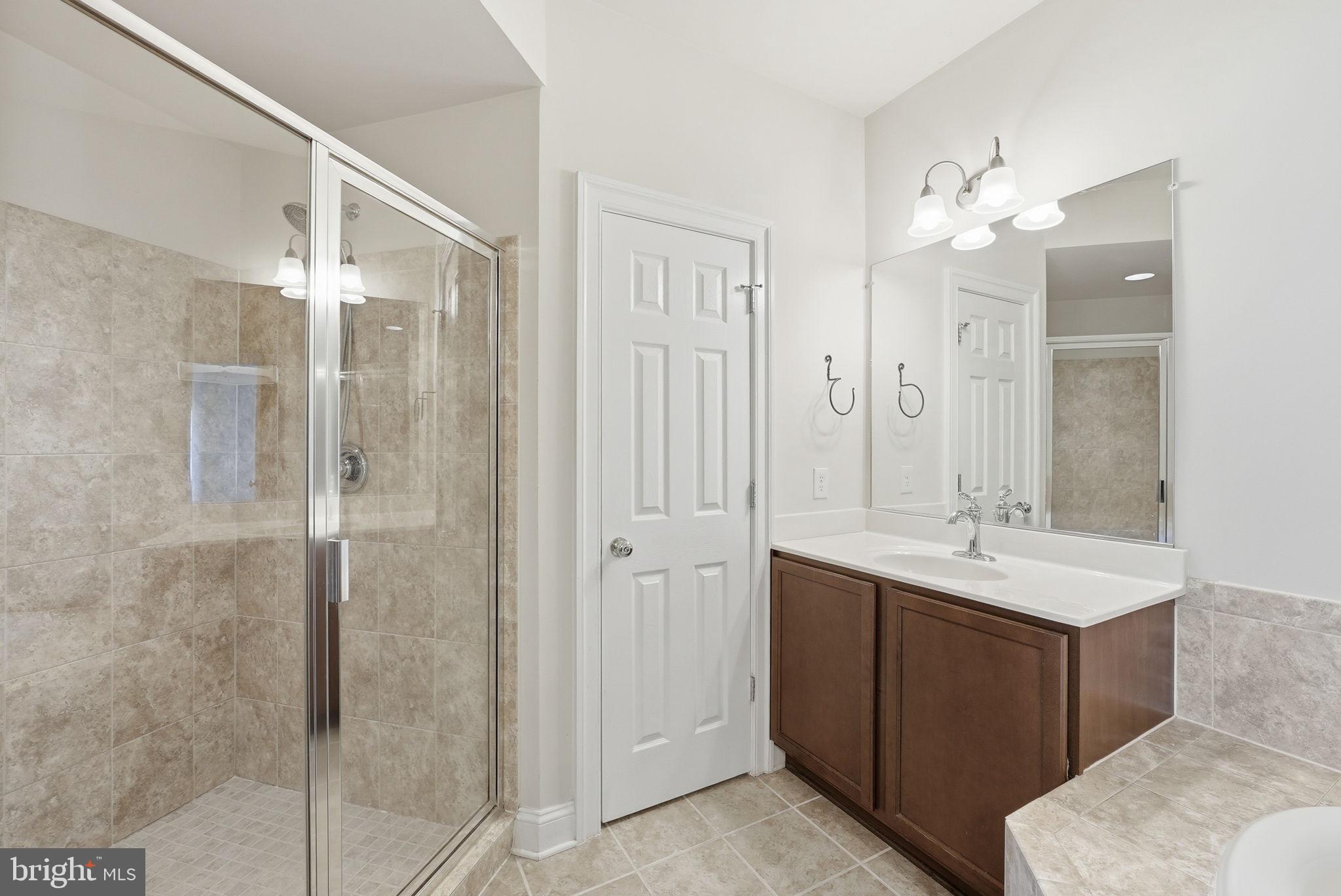 42330 Christophers View Terrace Ashburn, VA 20148 - Photo 34 of 46 a bathroom with a double vanity sink mirror and shower