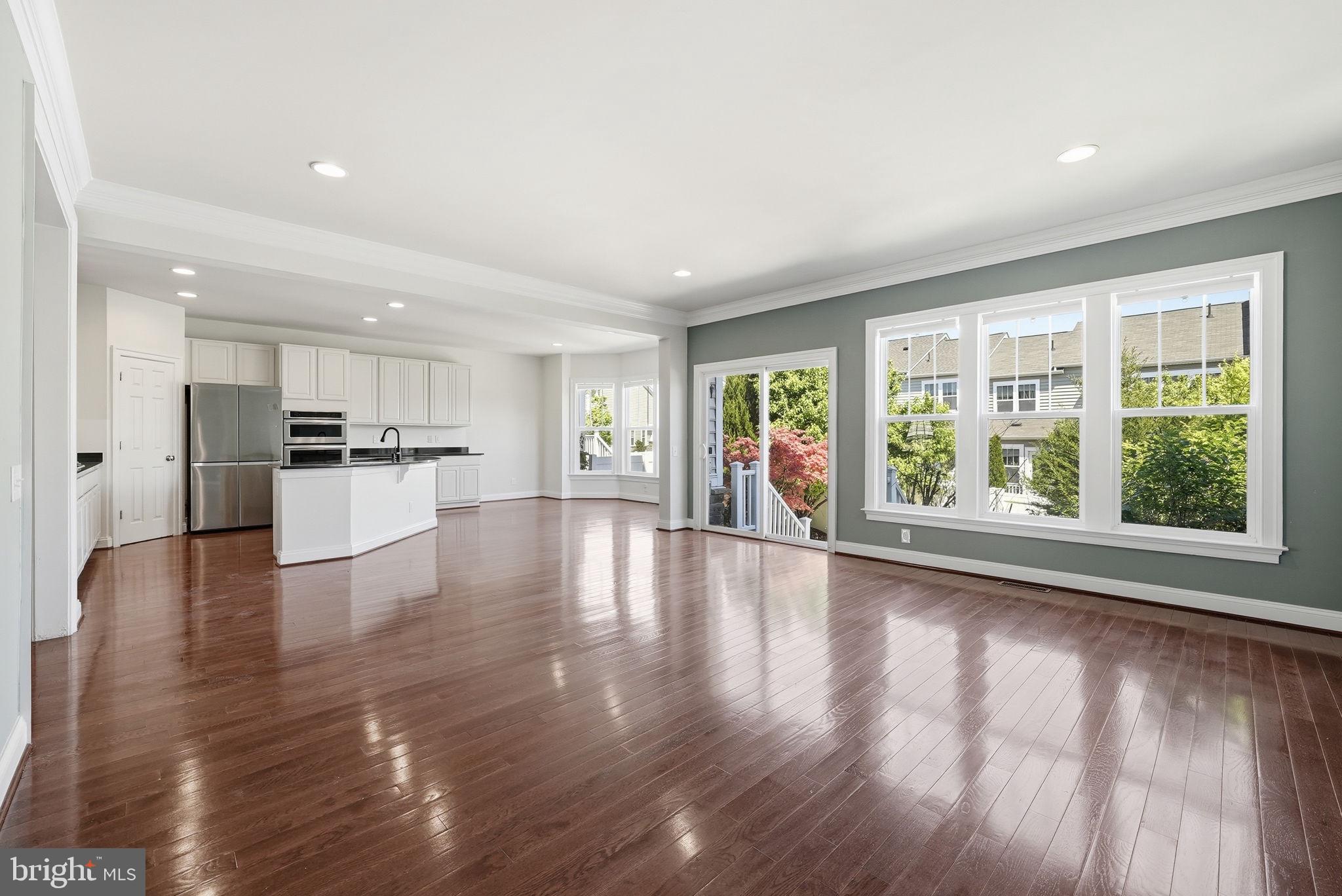42330 Christophers View Terrace Ashburn, VA 20148 - Photo 8 of 46 a view of an empty room with kitchen view and a window