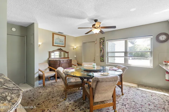a dining room with a wooden table and chairs