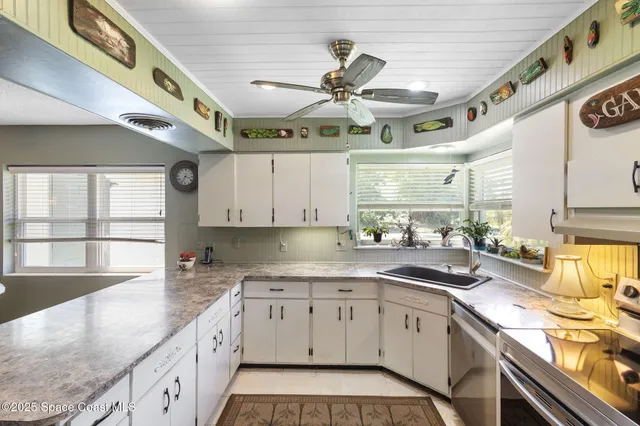 a kitchen with stainless steel appliances granite countertop a sink and cabinets