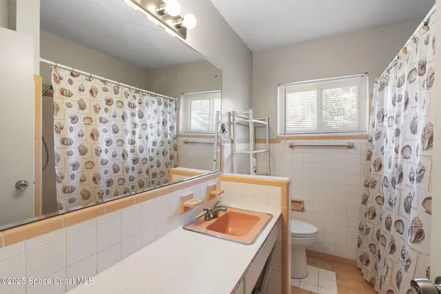 a bathroom with a sink toilet tub and shower