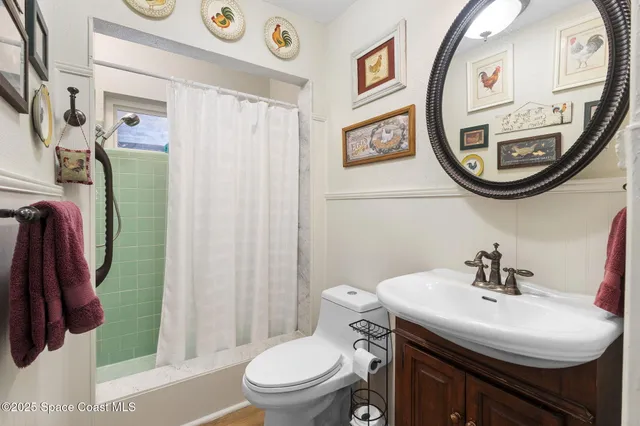 a bathroom with a sink mirror and toilet