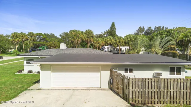 an aerial view of house with yard swimming pool and outdoor seating