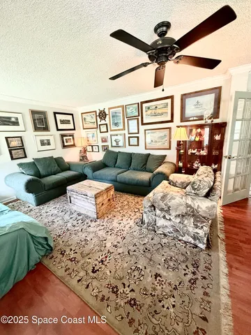 a bedroom with furniture and a large window