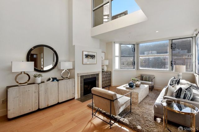 a living room with furniture a window and a fireplace