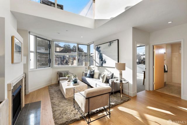 a living room with furniture or fireplace and a table