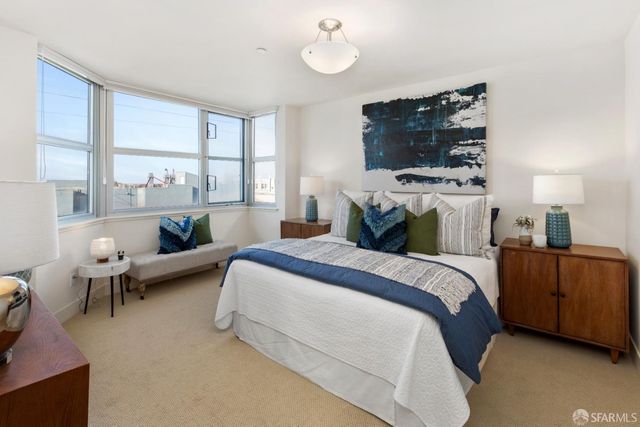 a spacious bedroom with a bed and window