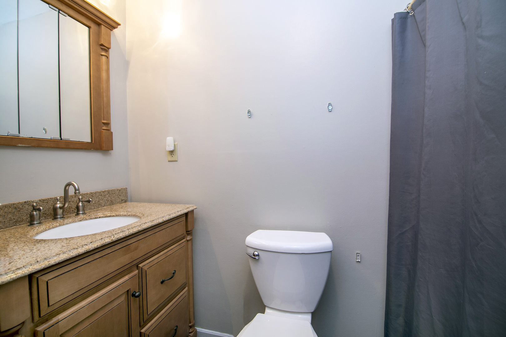 3926 East Chestnut Street Kankakee, IL 60901 - Photo 5 of 14 a bathroom with a toilet sink and mirror