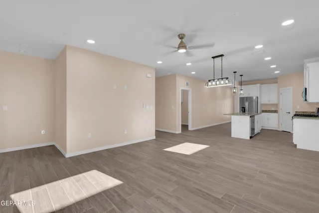 a view of kitchen with refrigerator and window